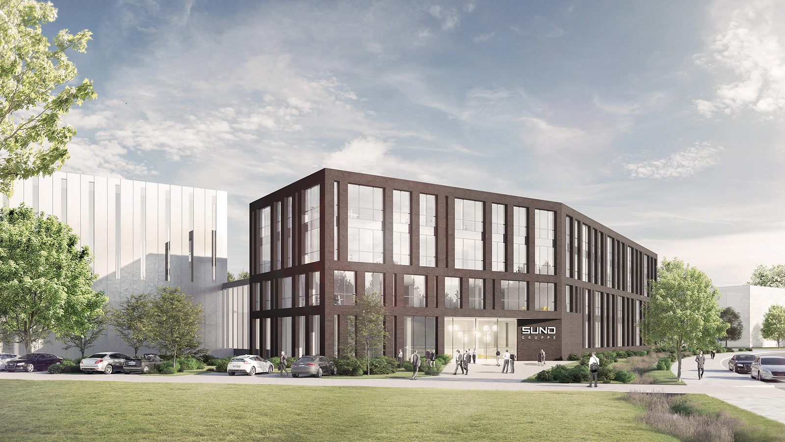 Ganzes Gebäude und im Vordergrund ist eine Wiese