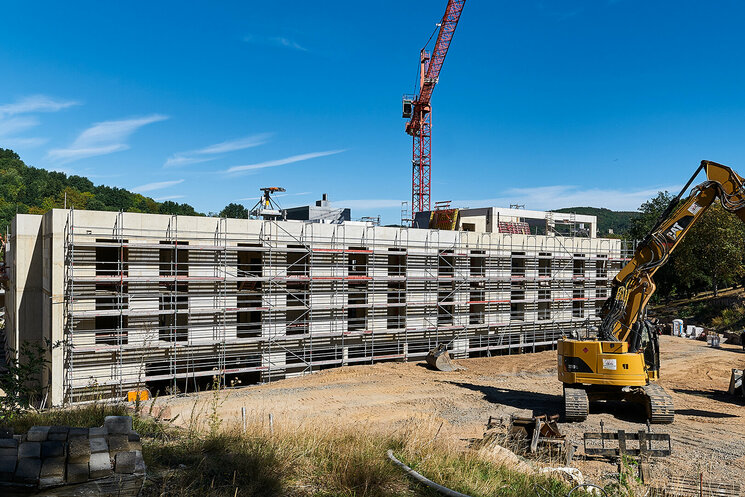 Bauzustand Außenansicht mit Bagger und Kran